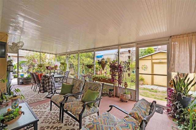 sunroom featuring outdoor dining area