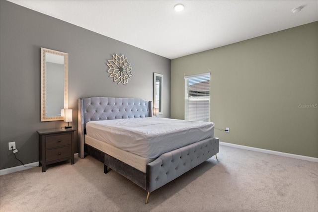 bedroom featuring baseboards and light colored carpet