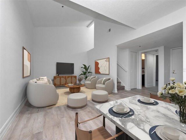 1092 E Michigan St Unit 1, Orlando, FL 32806 - living room featuring stairway, light wood-style floors, and baseboards