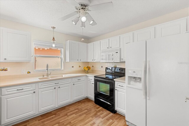 kitchen featuring white cabinets, a sink, tasteful backsplash, and white appliances