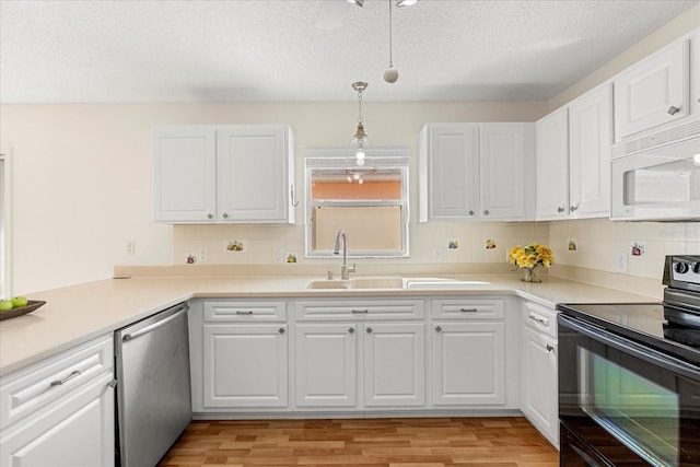 kitchen featuring white cabinetry, a sink, dishwasher, black range with electric stovetop, and white microwave