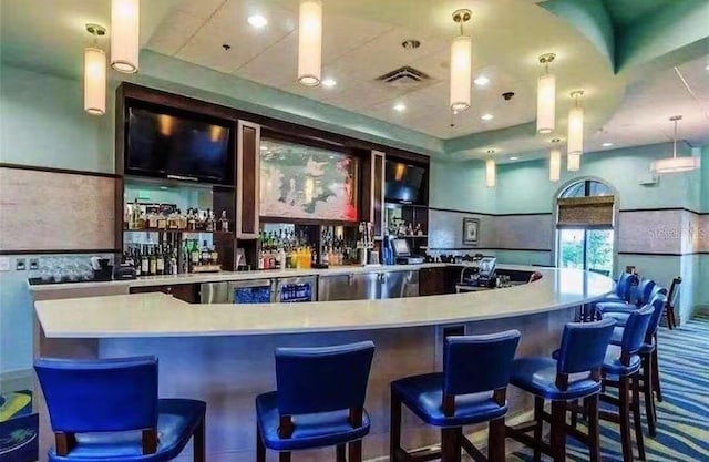 1584 Plunker Dr, Davenport, FL 33896 - bar featuring a community bar, visible vents, carpet, and decorative light fixtures