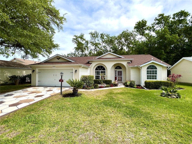 4638 River Ridge Drive, Leesburg, FL 34748 - view of front facade featuring a front lawn, concrete driveway, an attached garage, and a shingled roof