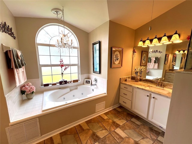 4638 River Ridge Drive, Leesburg, FL 34748 - bathroom featuring visible vents, a whirlpool tub, vaulted ceiling, a notable chandelier, and vanity