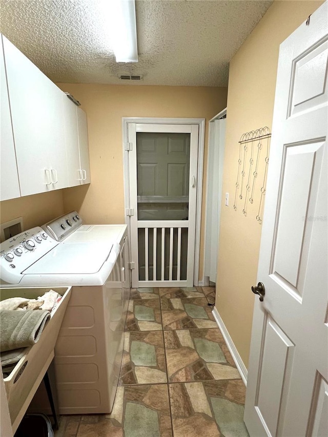 4638 River Ridge Drive, Leesburg, FL 34748 - laundry area with visible vents, stone finish floor, cabinet space, a textured ceiling, and independent washer and dryer