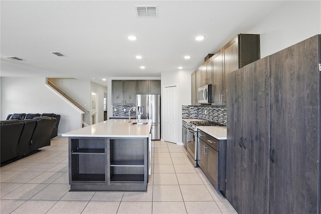 1158 Oak Bluff Dr, Davenport, FL 33837 - kitchen featuring appliances with stainless steel finishes, decorative backsplash, light tile patterned flooring, light countertops, and recessed lighting