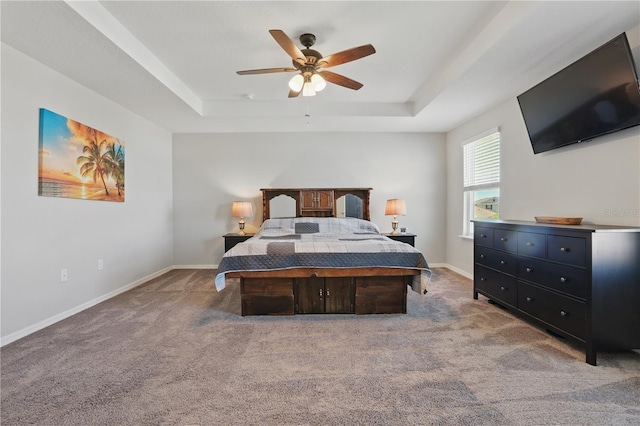 1158 Oak Bluff Dr, Davenport, FL 33837 - bedroom with a raised ceiling, light carpet, and a ceiling fan