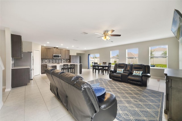1158 Oak Bluff Dr, Davenport, FL 33837 - living room with light tile patterned floors, a ceiling fan, healthy amount of natural light, and recessed lighting