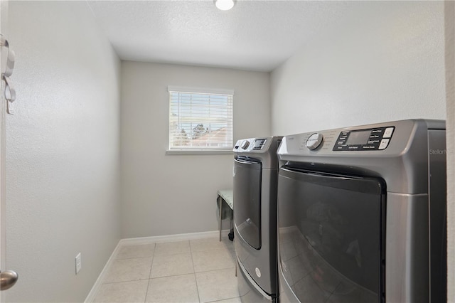 1158 Oak Bluff Dr, Davenport, FL 33837 - laundry room with washing machine and dryer, tile patterned floors, and a textured ceiling