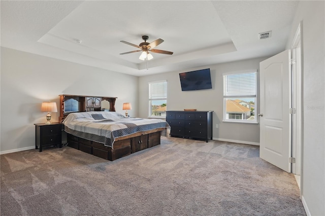 1158 Oak Bluff Dr, Davenport, FL 33837 - bedroom featuring a raised ceiling, carpet flooring, multiple windows, and ceiling fan