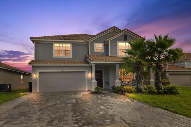 1158 Oak Bluff Dr, Davenport, FL 33837 - view of front facade featuring a tiled roof, decorative driveway, a garage, and stucco siding