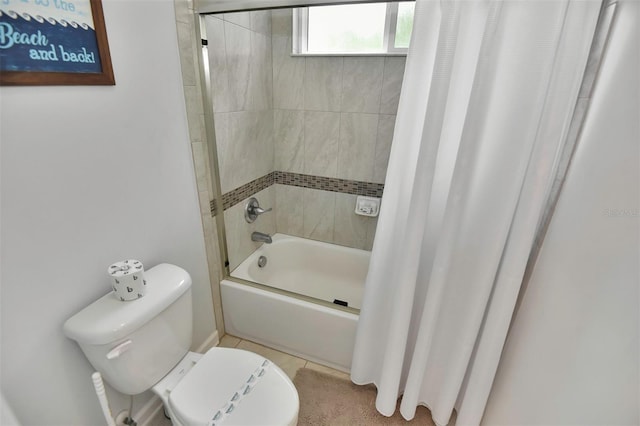 bathroom with toilet, shower / bath combo, and tile patterned flooring