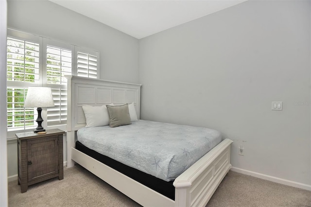 carpeted bedroom with baseboards