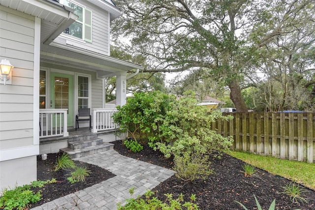 view of yard featuring fence and a porch