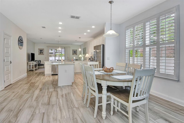 dining space featuring baseboards, visible vents, and recessed lighting