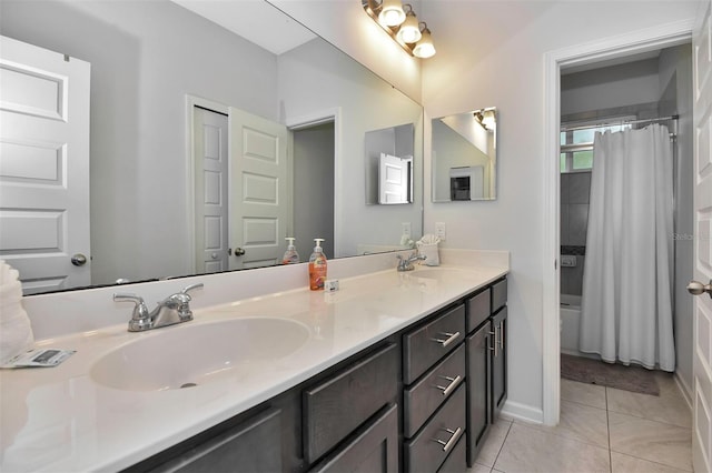 bathroom with tile patterned floors, double vanity, a sink, and shower / bath combo with shower curtain