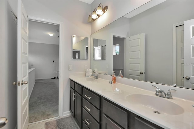 full bath featuring double vanity, a sink, and tile patterned floors
