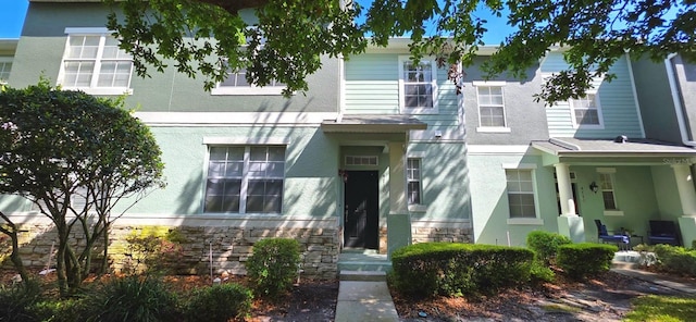 4730 Capital Blvd, Saint Cloud, FL 34769 - townhome / multi-family property featuring stone siding and stucco siding
