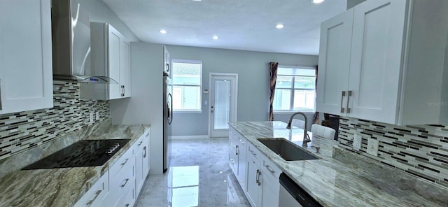 4730 Capital Blvd, Saint Cloud, FL 34769 - kitchen with a sink, wall chimney exhaust hood, tasteful backsplash, stainless steel appliances, and white cabinets