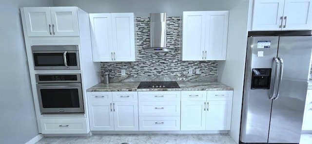 4730 Capital Blvd, Saint Cloud, FL 34769 - kitchen featuring decorative backsplash, white cabinetry, wall chimney range hood, and stainless steel appliances