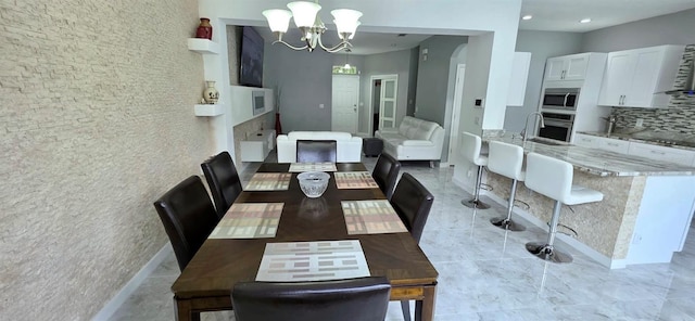 4730 Capital Blvd, Saint Cloud, FL 34769 - dining area featuring baseboards and an inviting chandelier