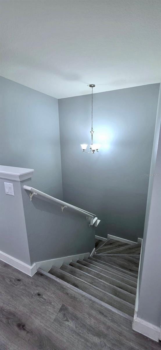 4730 Capital Blvd, Saint Cloud, FL 34769 - staircase featuring baseboards and wood finished floors