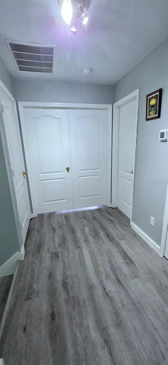 4730 Capital Blvd, Saint Cloud, FL 34769 - unfurnished bedroom with wood finished floors, baseboards, and visible vents