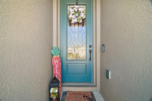 doorway to property with stucco siding