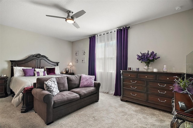 bedroom with light colored carpet and ceiling fan