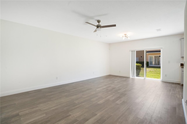 10124 Shadow Leaf Ct, Orlando, FL 32825 - unfurnished room with dark wood-type flooring, visible vents, ceiling fan, and baseboards