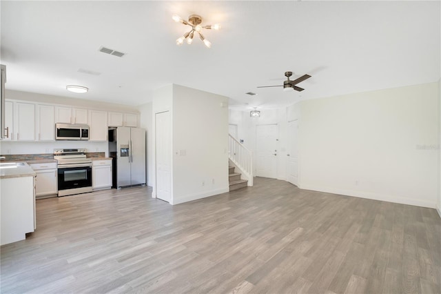 10124 Shadow Leaf Ct, Orlando, FL 32825 - kitchen featuring open floor plan, appliances with stainless steel finishes, light wood finished floors, and visible vents