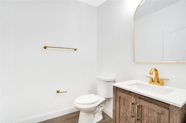 10124 Shadow Leaf Ct, Orlando, FL 32825 - bathroom with toilet, vanity, baseboards, and wood finished floors