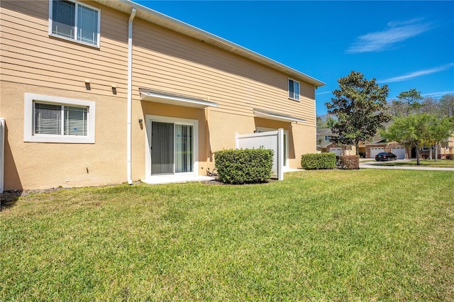 10124 Shadow Leaf Ct, Orlando, FL 32825 - back of house featuring stucco siding and a yard