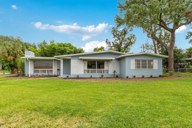 3107 Troy Dr, Orlando, FL 32806 - ranch-style home featuring a front yard, fence, brick siding, and a chimney