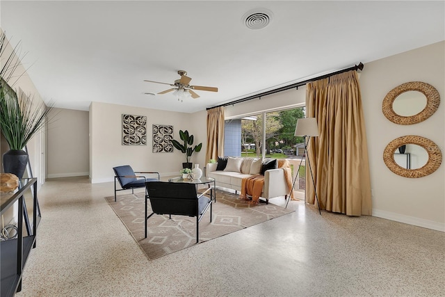 3107 Troy Dr, Orlando, FL 32806 - living area with speckled floor, baseboards, a ceiling fan, and visible vents