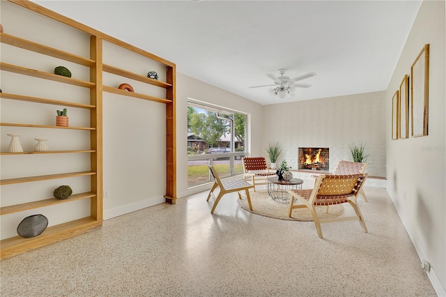3107 Troy Dr, Orlando, FL 32806 - living room featuring baseboards, wallpapered walls, a brick fireplace, speckled floor, and ceiling fan