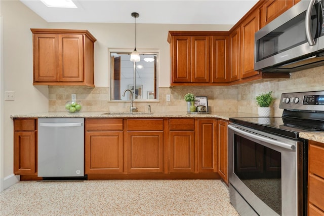 3107 Troy Dr, Orlando, FL 32806 - kitchen with tasteful backsplash, a sink, appliances with stainless steel finishes, brown cabinetry, and pendant lighting
