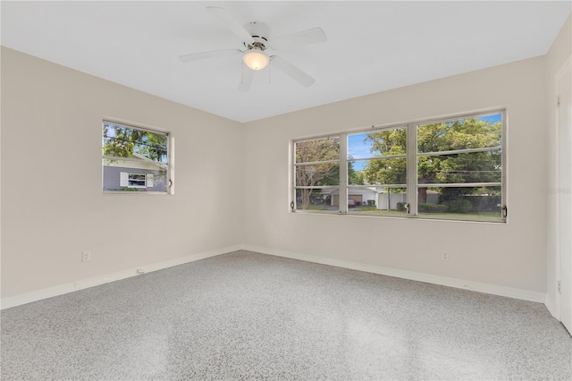 3107 Troy Dr, Orlando, FL 32806 - spare room with speckled floor, ceiling fan, plenty of natural light, and baseboards