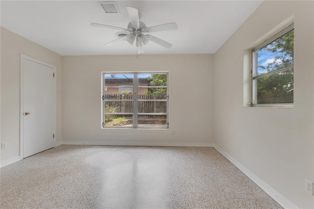 3107 Troy Dr, Orlando, FL 32806 - empty room with ceiling fan, baseboards, and a healthy amount of sunlight