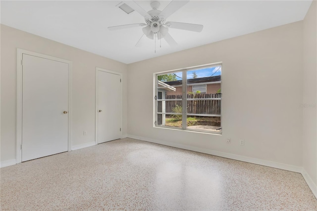 3107 Troy Dr, Orlando, FL 32806 - unfurnished bedroom featuring speckled floor, baseboards, and a ceiling fan