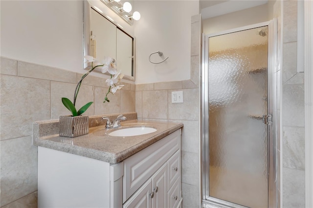 3107 Troy Dr, Orlando, FL 32806 - full bath featuring a stall shower, vanity, and tile walls