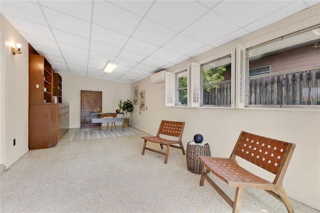 3107 Troy Dr, Orlando, FL 32806 - living area featuring a paneled ceiling, baseboards, and an AC wall unit