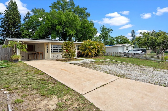 6031 W Ridgewood Ave, Orlando, FL 32835 - view of front of property with concrete driveway and a carport