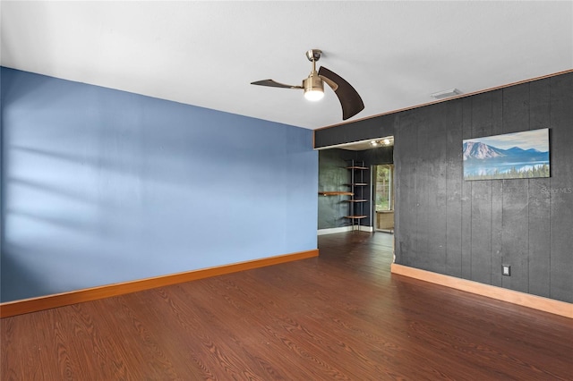 6031 W Ridgewood Ave, Orlando, FL 32835 - spare room featuring ceiling fan, wooden walls, and wood finished floors