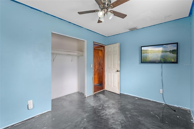 6031 W Ridgewood Ave, Orlando, FL 32835 - unfurnished bedroom with concrete floors, a closet, and a ceiling fan