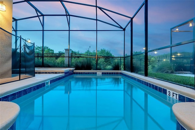 2805 Bookmark Dr, Kissimmee, FL 34746 - pool at dusk featuring a lanai, an outdoor pool, and fence
