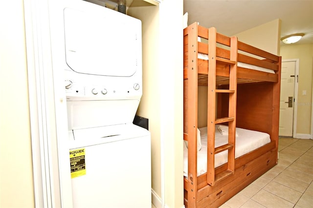 13427 Blue Heron Beach Dr Unit 1802, Orlando, FL 32821 - clothes washing area featuring light tile patterned floors, stacked washer and clothes dryer, and laundry area