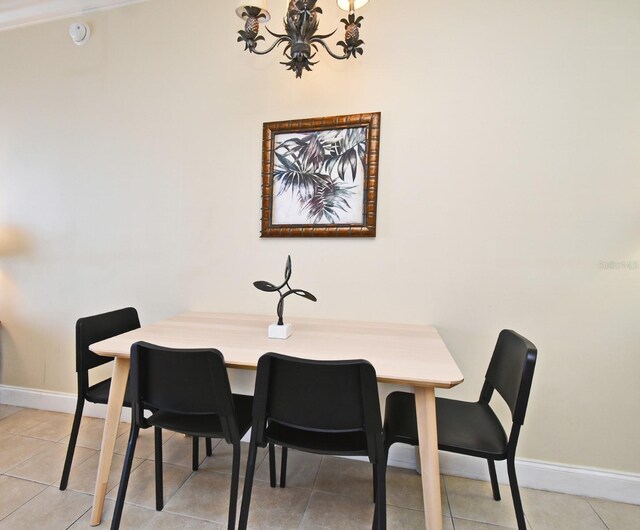 13427 Blue Heron Beach Dr Unit 1802, Orlando, FL 32821 - dining space with baseboards, an inviting chandelier, and light tile patterned floors