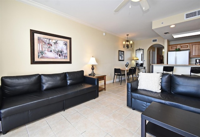 13427 Blue Heron Beach Dr Unit 1802, Orlando, FL 32821 - living area featuring visible vents, crown molding, arched walkways, ceiling fan with notable chandelier, and light tile patterned floors