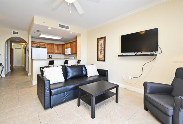 13427 Blue Heron Beach Dr Unit 1802, Orlando, FL 32821 - living area with light tile patterned floors, baseboards, visible vents, arched walkways, and ceiling fan